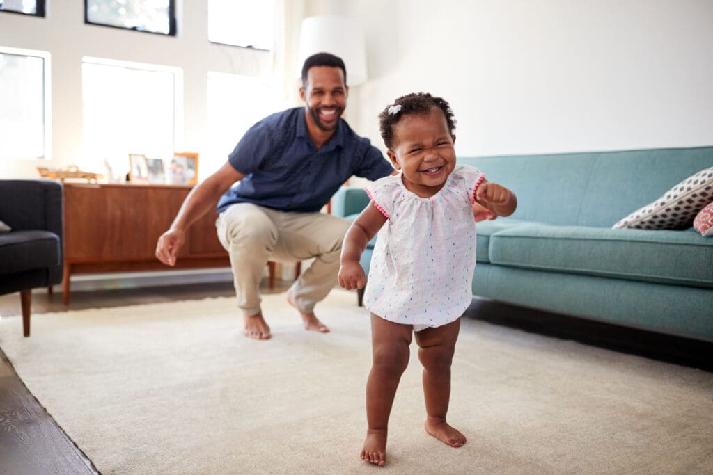 A man and child playing with a remote control.