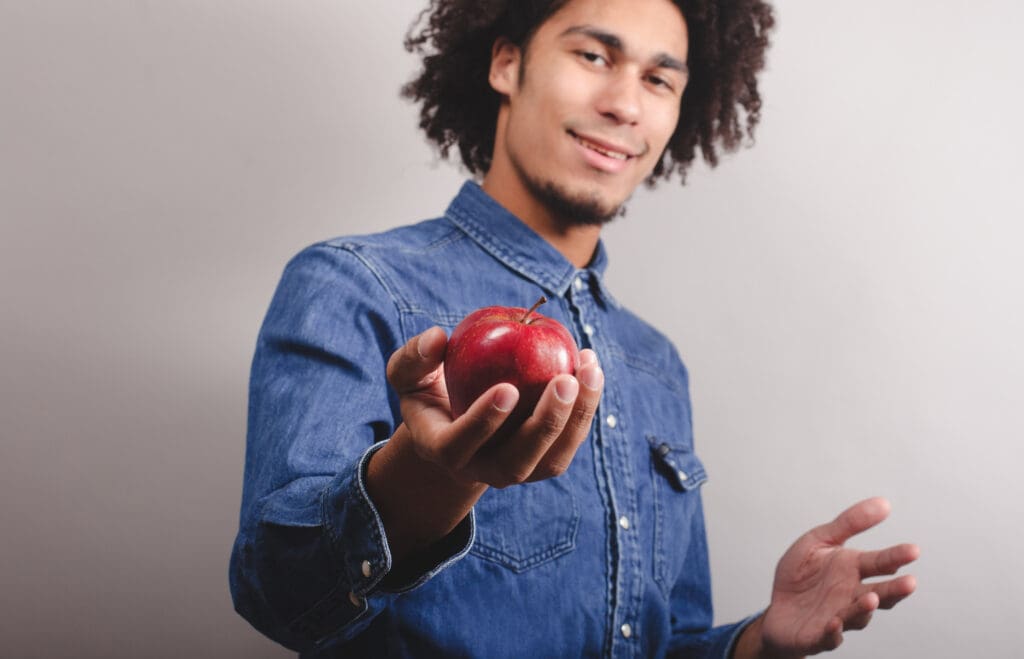 A man holding an apple in his hands.