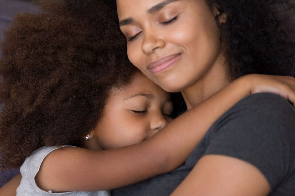 A young black women loving her daughter