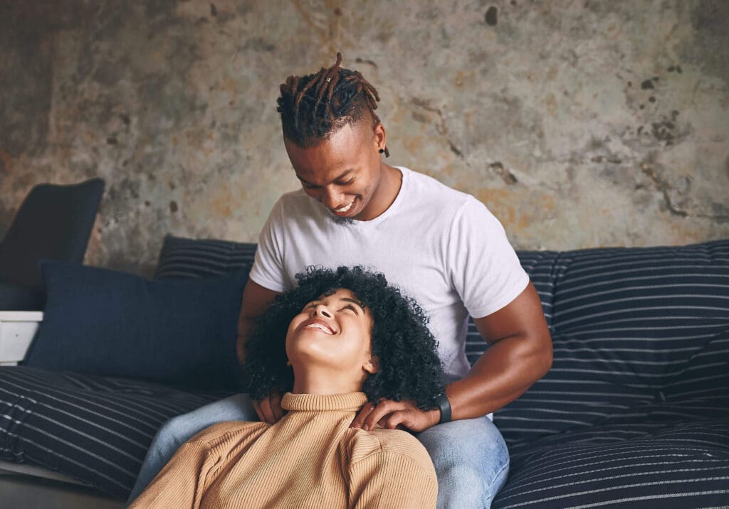 A young man leaning on a black women
