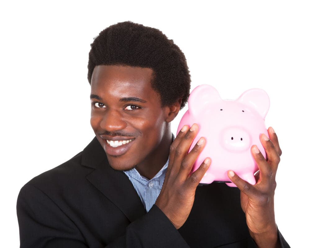 A man holding a pink piggy bank in front of him.