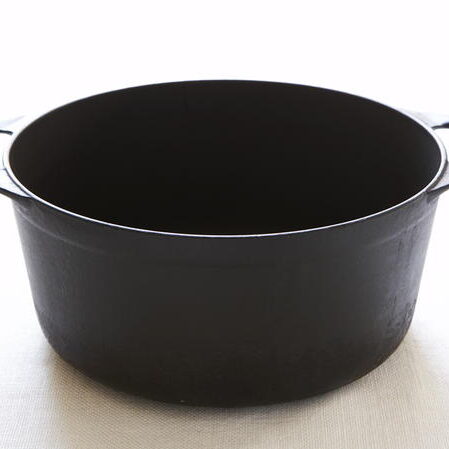 A black pot sitting on top of a table.