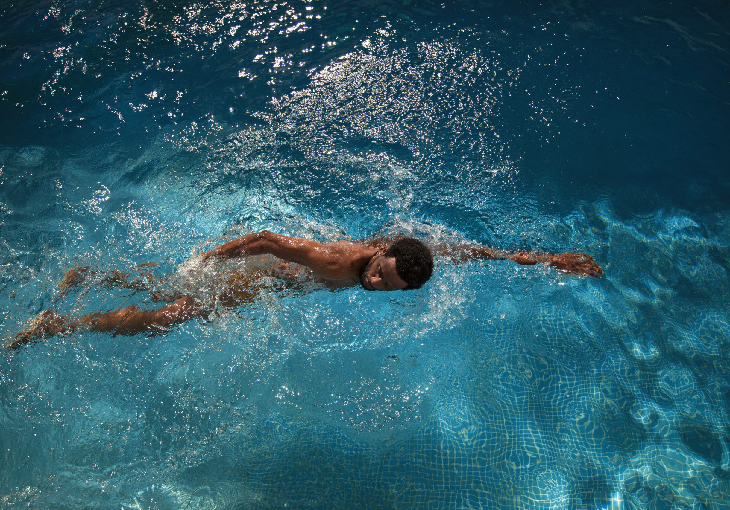 Young,Sporty,Man,Swimming,In,Blue,Water,Of,Pool.,Dark