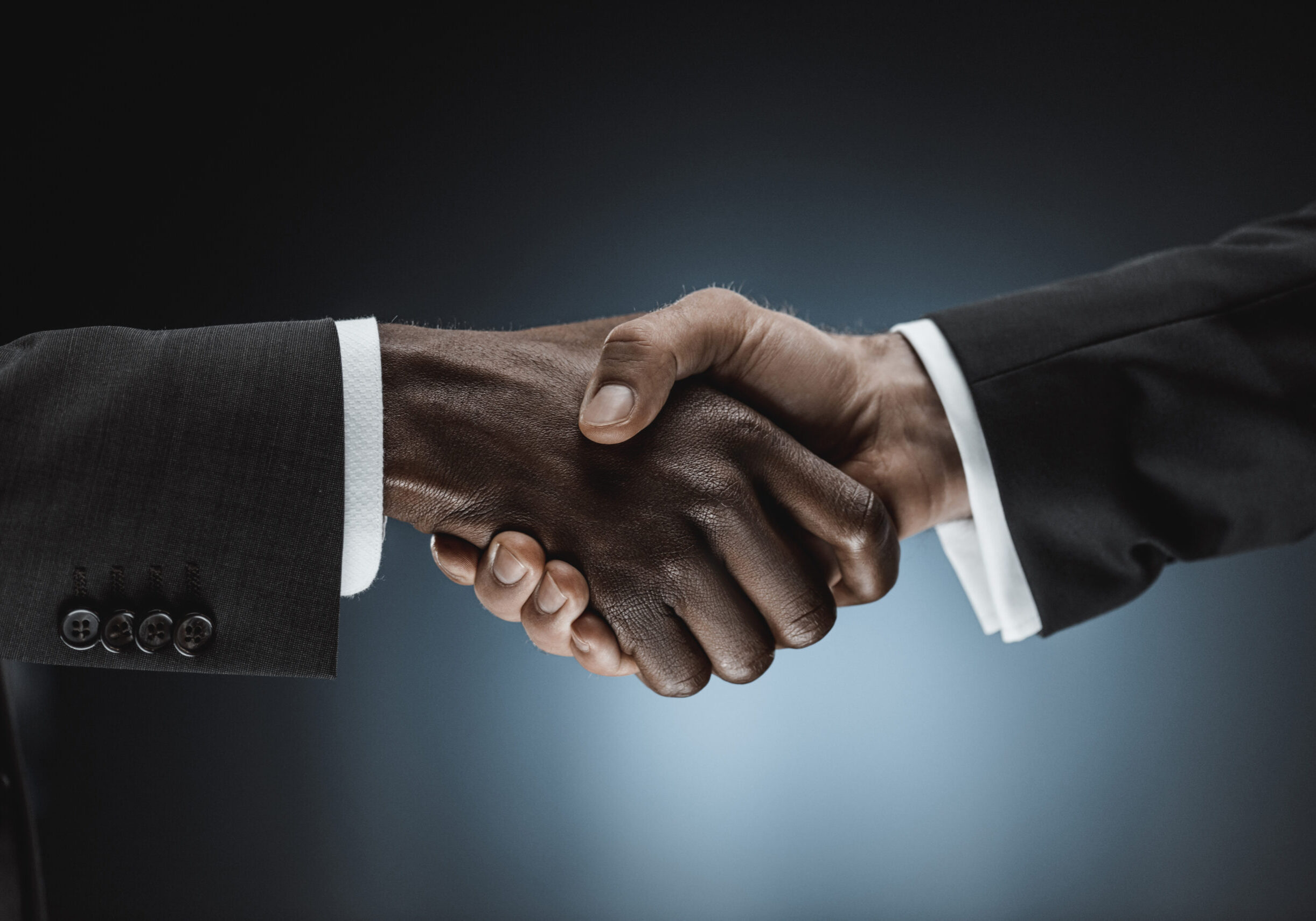 Cropped,Shot,Of,Multicultural,Businessmen,Handshake,Isolated,On,Black