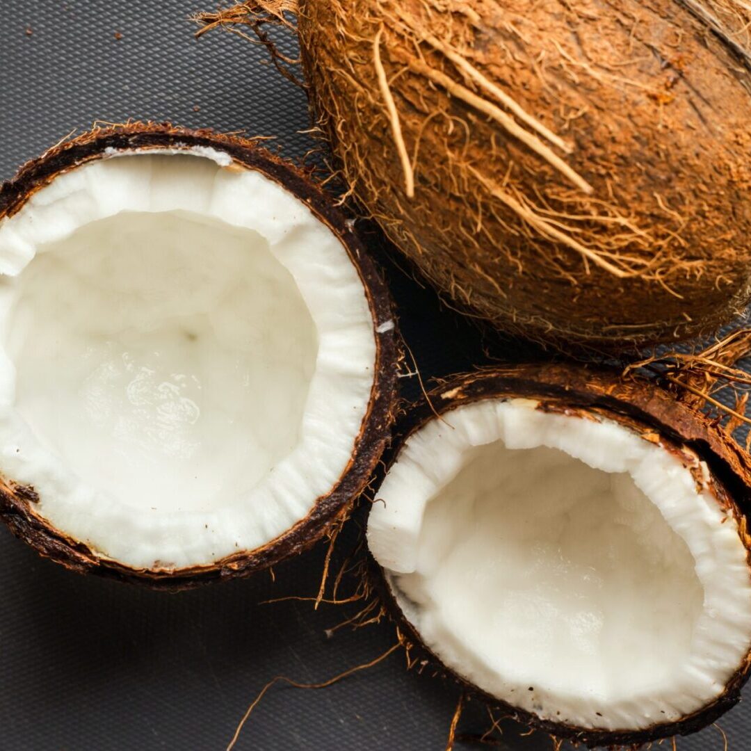 A close up of two coconuts on the ground